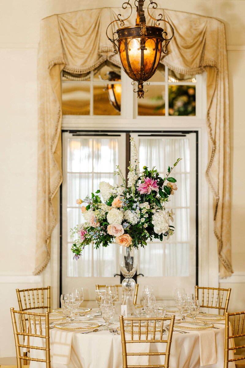 floral centerpiece and gold accents at reception