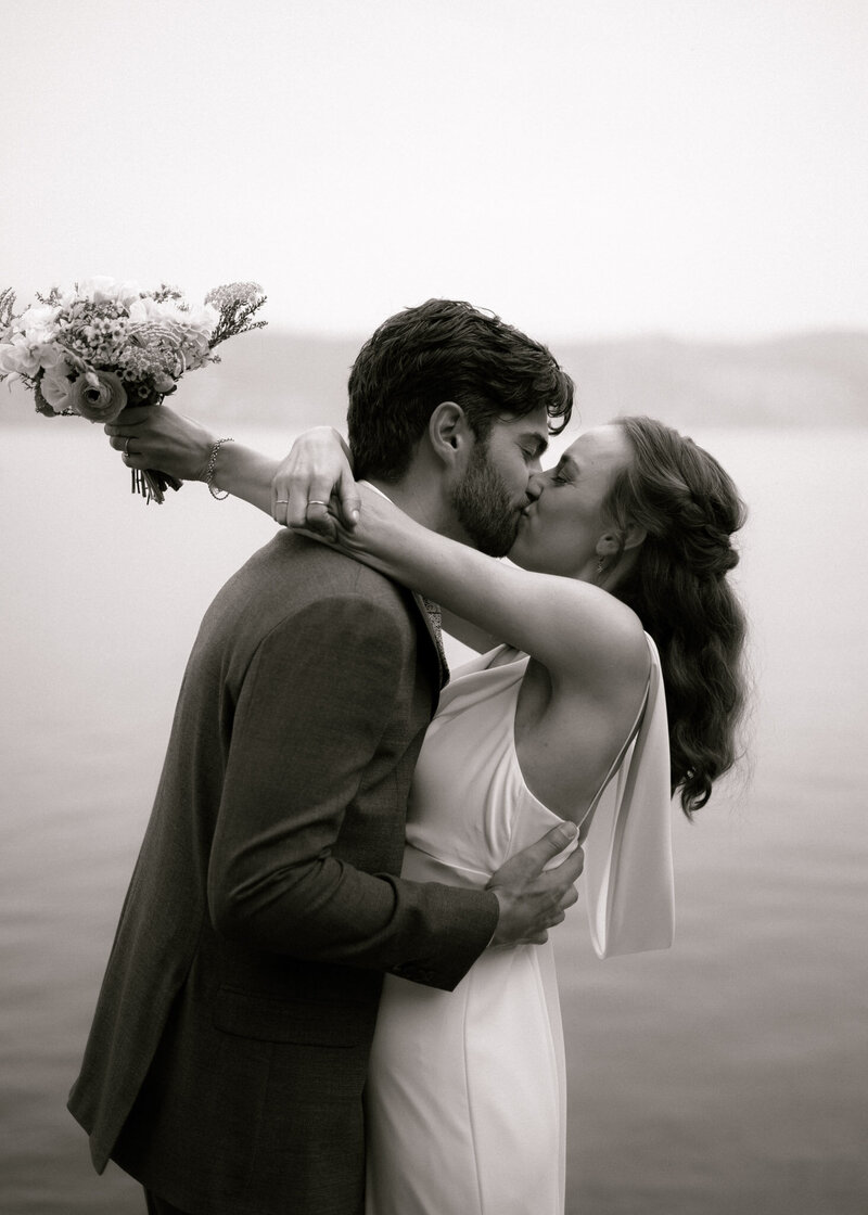 black and white portrait of a couple kissing on their wedding day