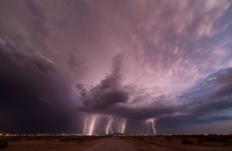 several lightning bolts striking the earth from a large cloud
