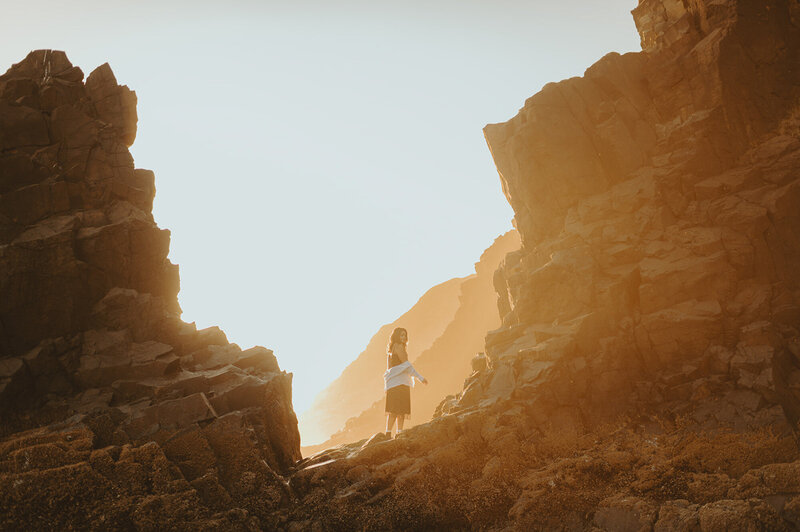 girl walking through canyon near the beach