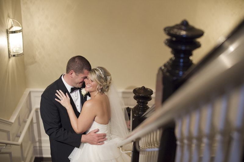 bride and groom posed on the stairs at clarks landing