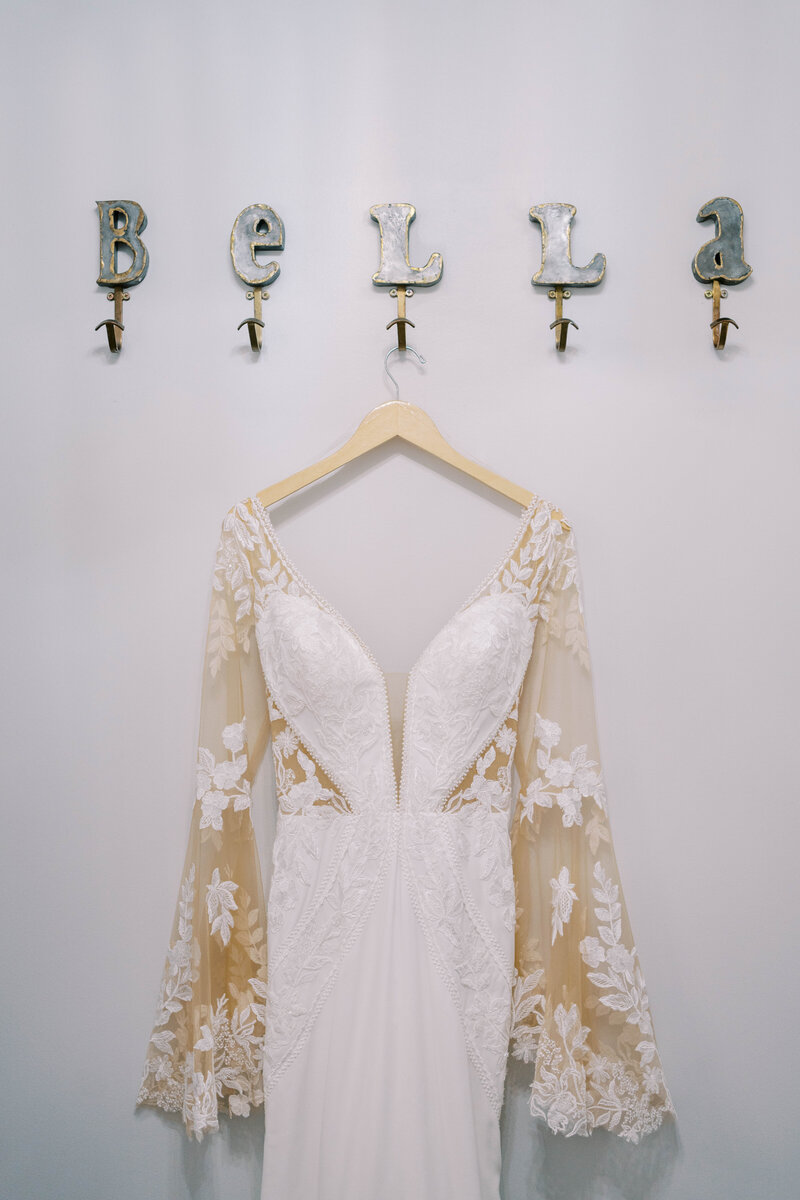 Wedding gown hangs on hooks