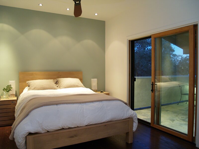 sliding glass doors in bedroom. soft-lighting in luxury bedroom design.