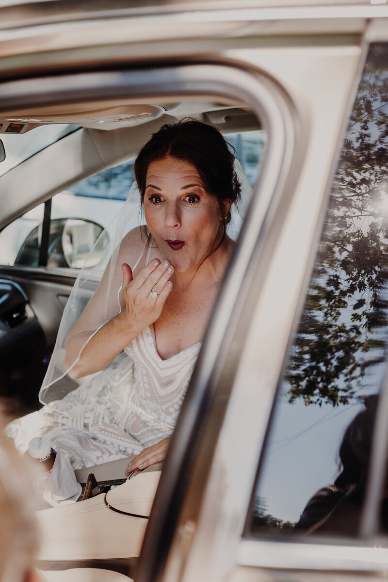 surprised bride in a car