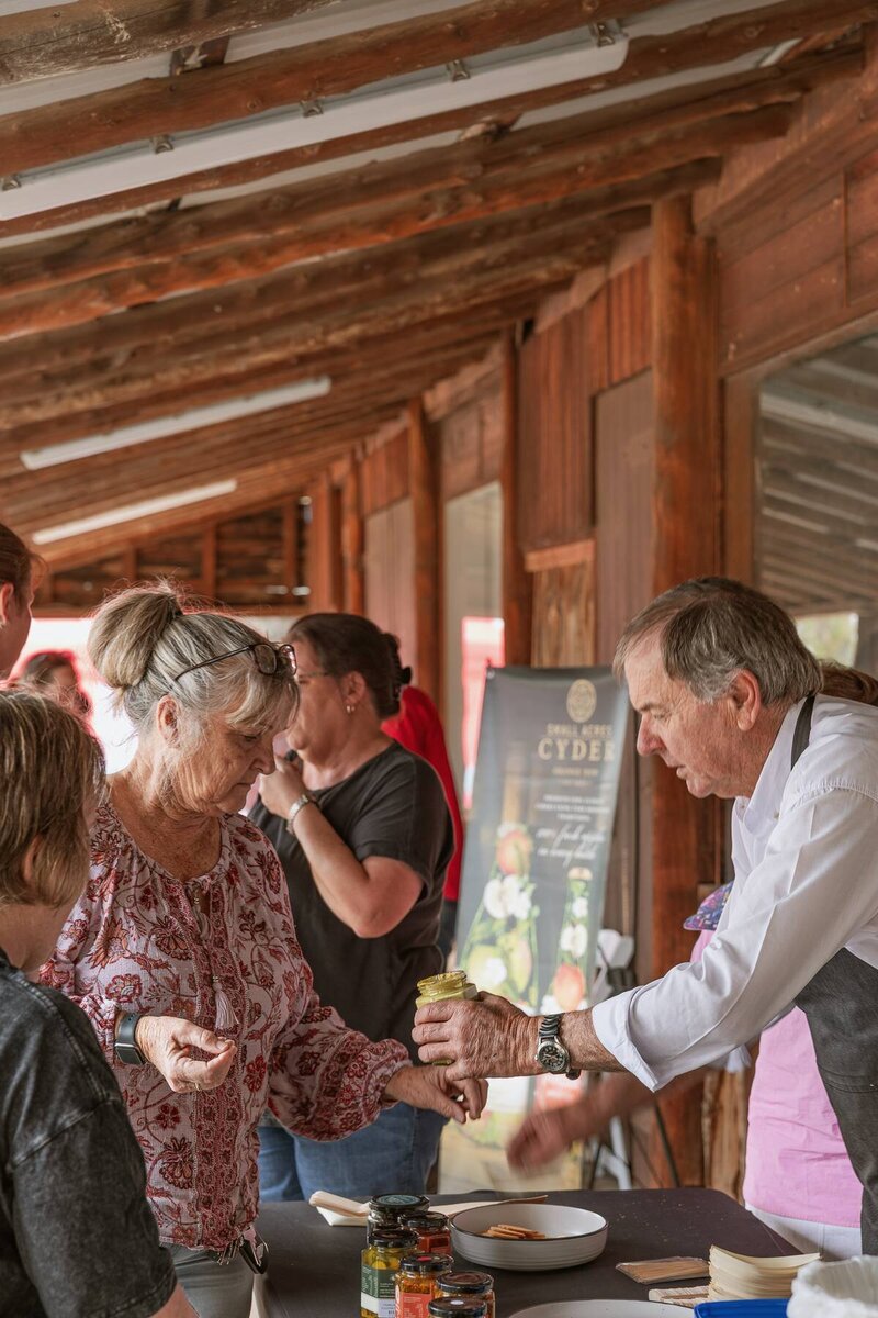 Guests engaging with stallholders at a local outdoor community event captured by event photographer