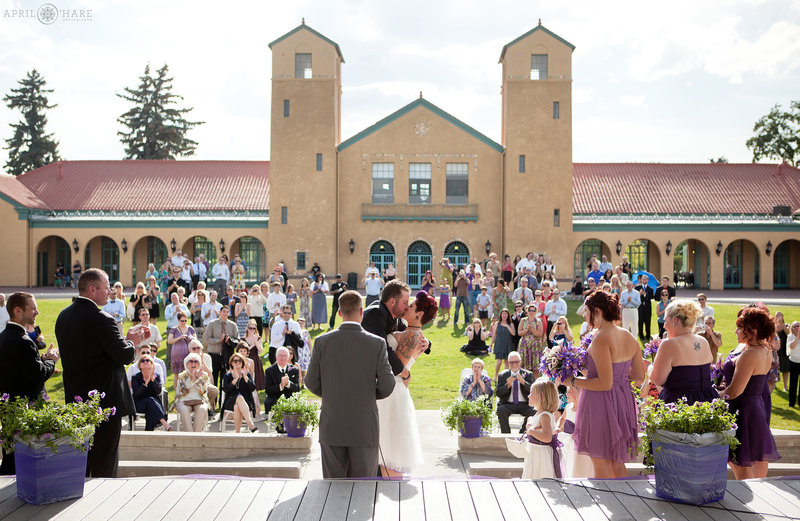 Bride and Groom Kiss at their outdoor City Park Pavilion Wedding Ceremony in Denver Colorado