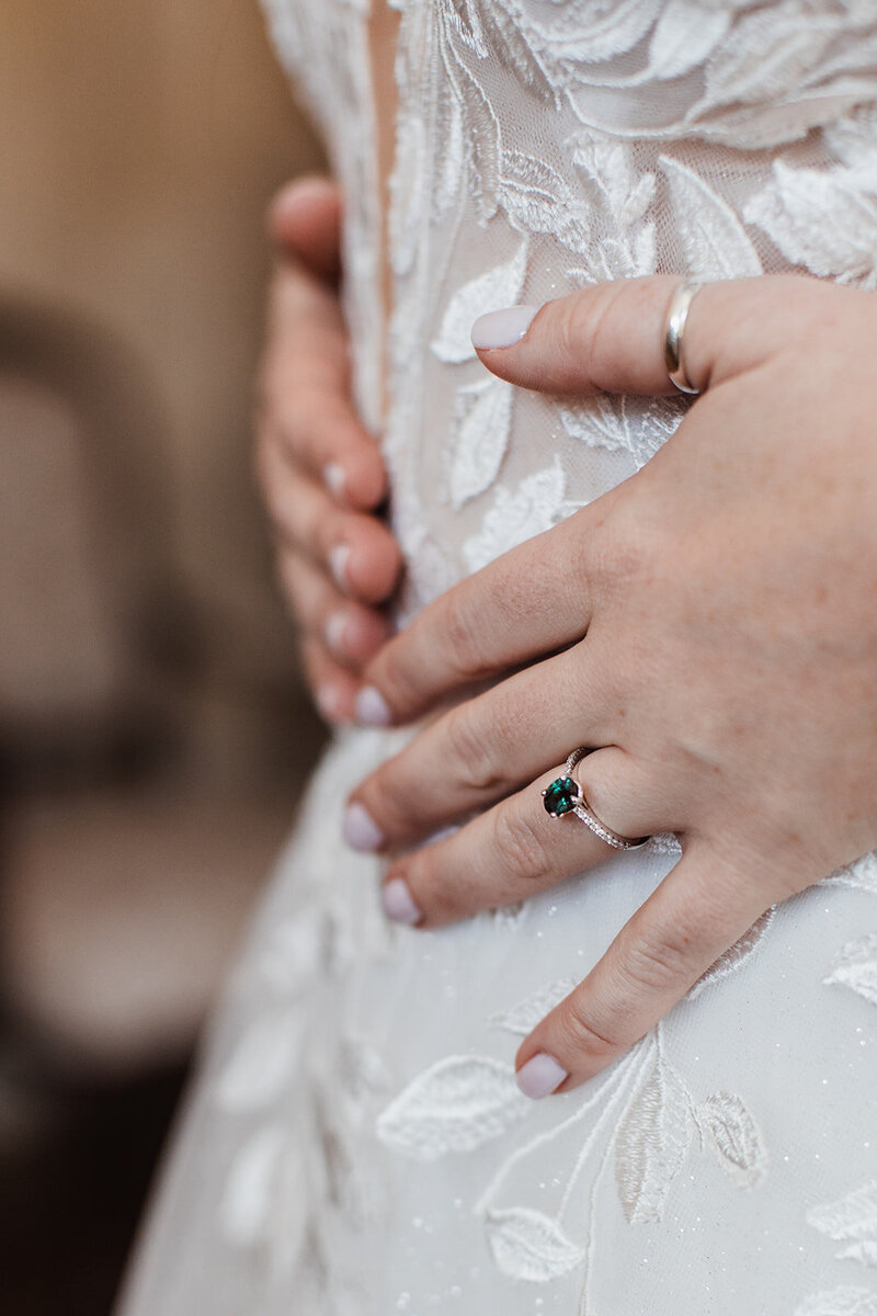 Detail photo of wedding ring and wedding dress at the Pierce house