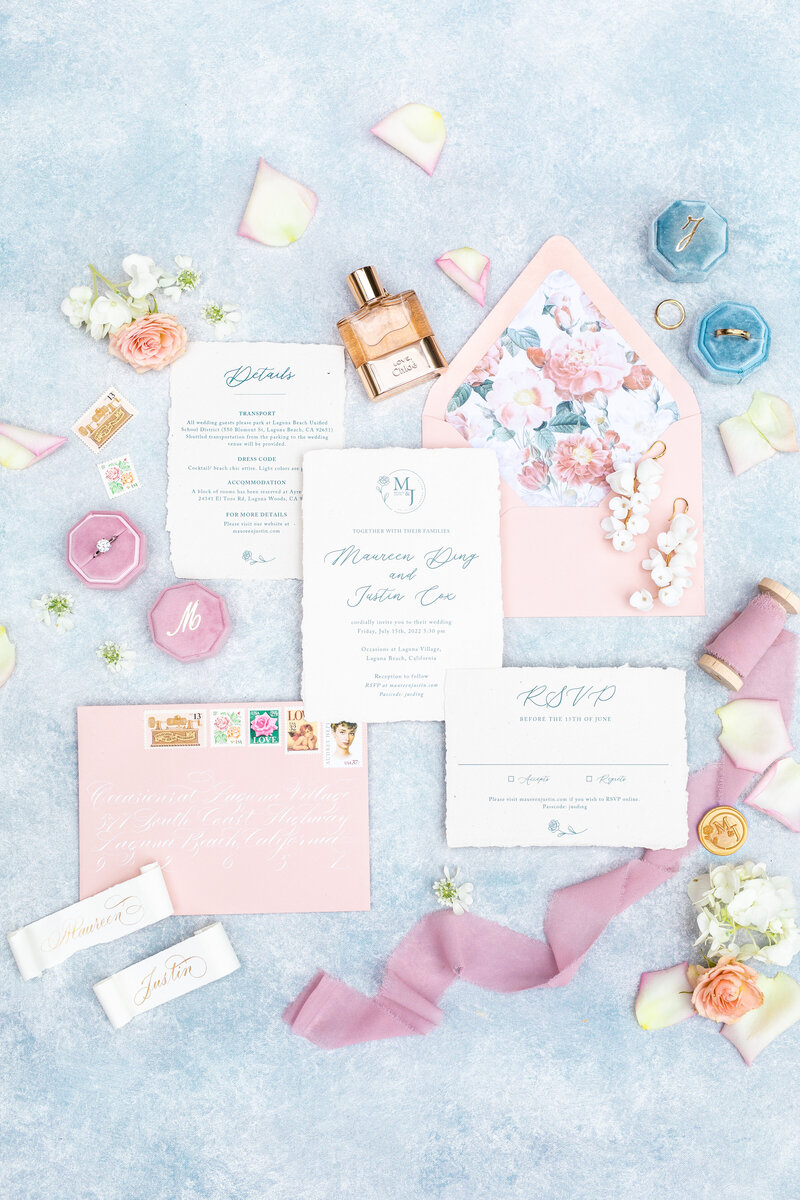 Wedding invitations, flowers, ring box, and rings in Laguna Beach, California - Sherr Weddings