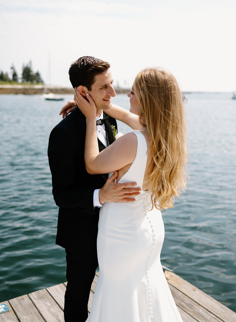 Bride and groom look lovingly into each other's eyes after wedding ceremony on the water at Newagen Seaside Inn, Boothbay Harbor, Maine