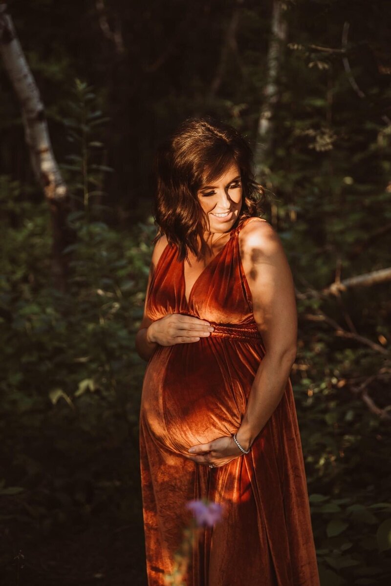 Pregnant woman posing in orange gown