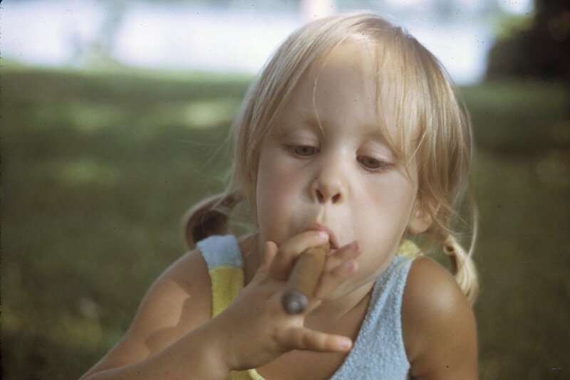 Annie X as a 4 year old smoking a cigar as a joke in Montreal, quebec