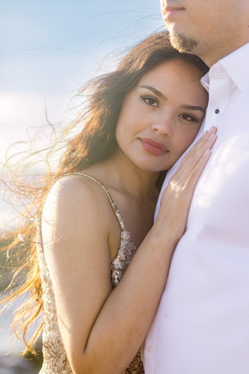 Golden light sunset engagement session on Maui by the cliffs on the North Shore with long gown