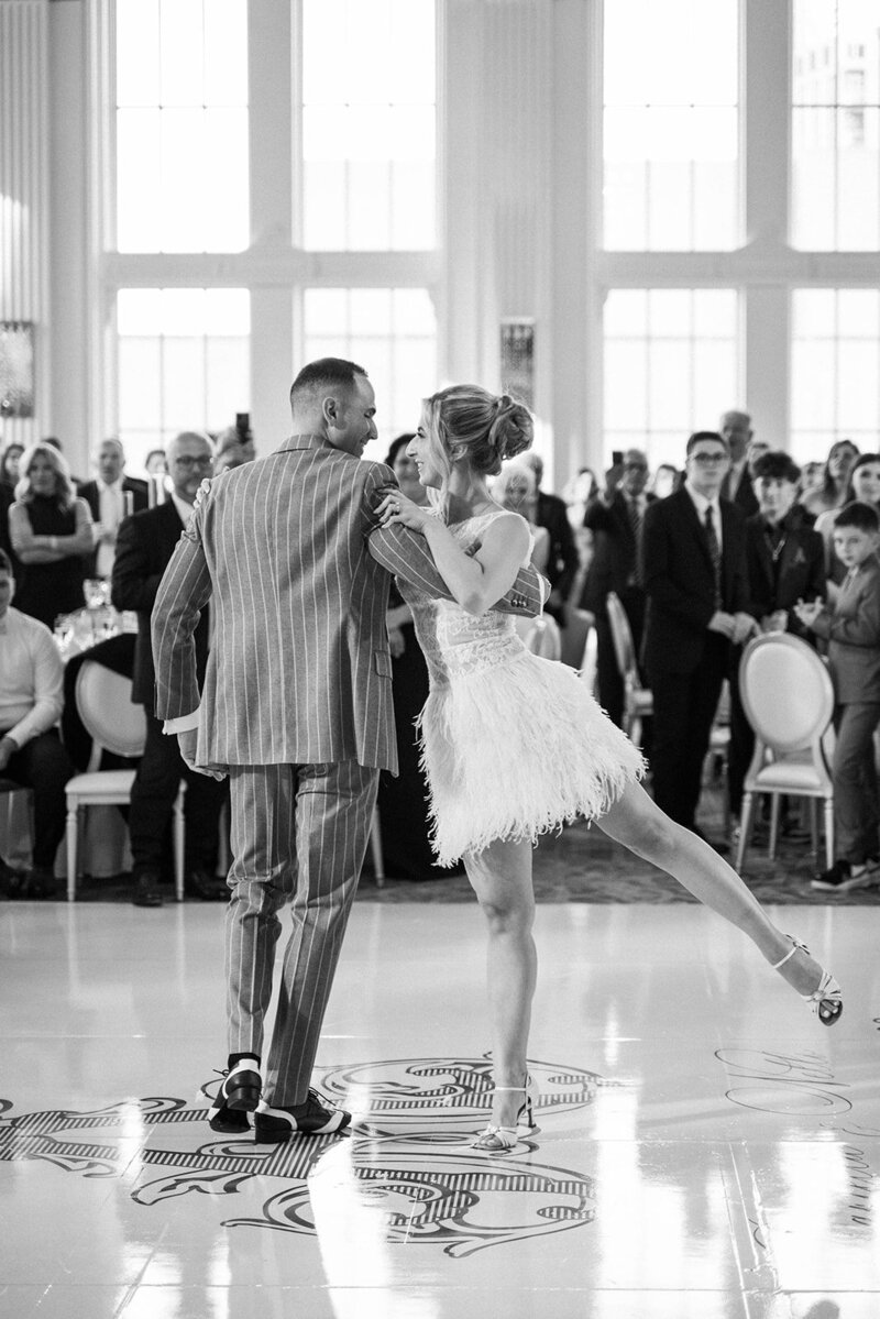 black and white photo of bride and groom dancing at theri wedding