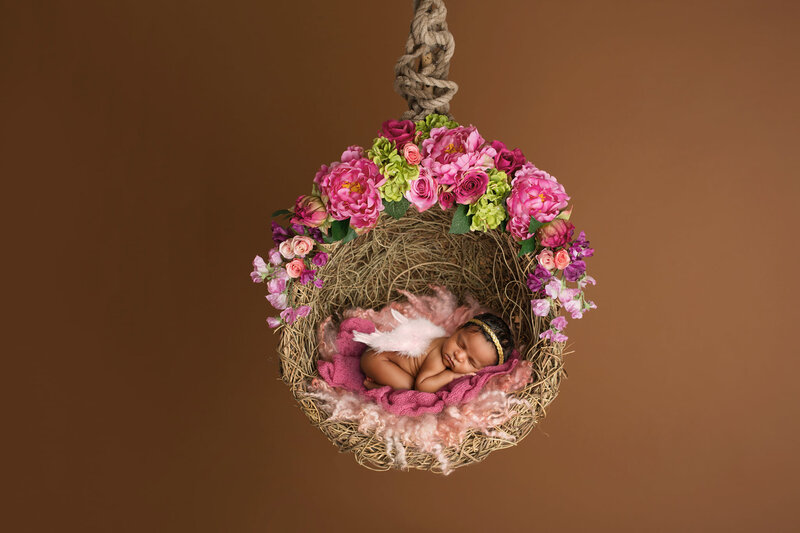 Baby posing in beautiful hoop floral swing