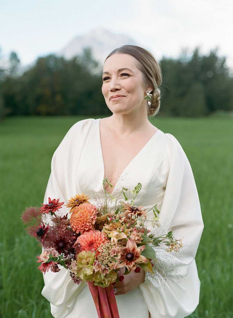 Bride holding wedding flowers in autumn tones