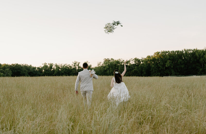 Wedding Photograph of a young middle eastern couple's wedding in Richmond, Virginia of them running off into the distance of a overgrown grass field