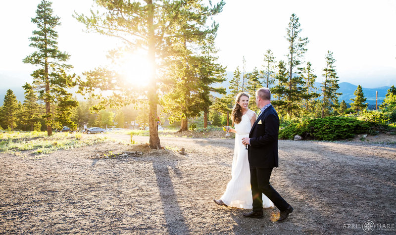 Couple walk hand in hand to their wedding reception at YMCA of the Rockies in Estes Park