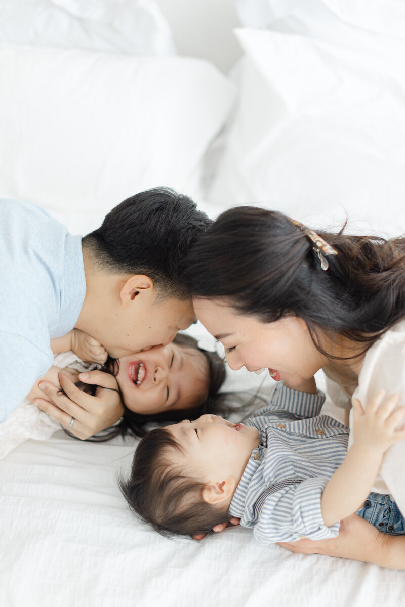 Parents snuggle their two babies