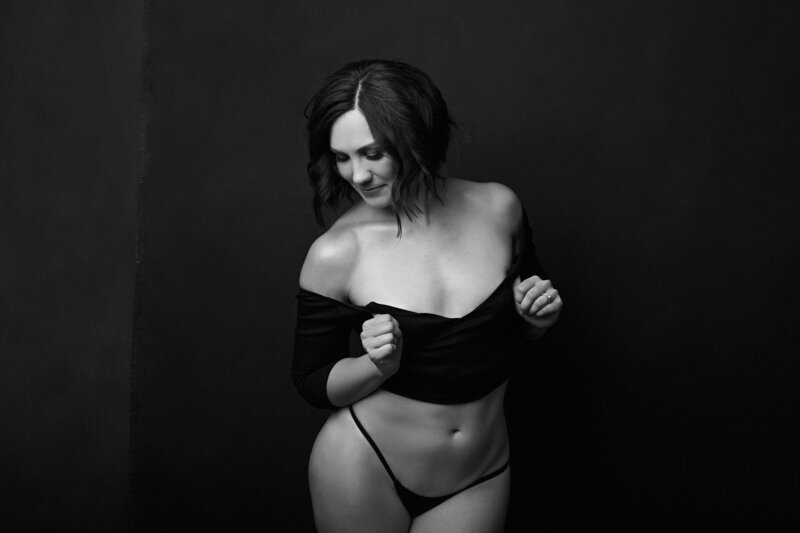 Studio boudoir portrait of a woman against a dark background