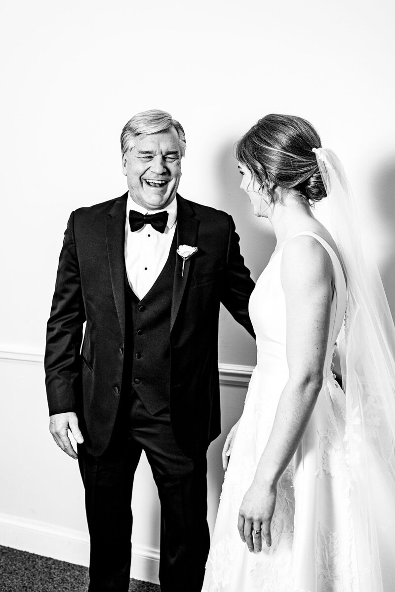 Black and white photo of the Father of the bride seeing his daughter in her wedding dress for the first time