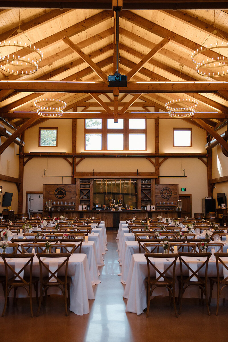a rustic barn wedding reception with long table settings at barnwood events, a wedding venue in madison, winconsin.
