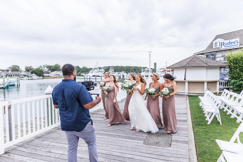 Wedding videographer videoing bridesmaids.