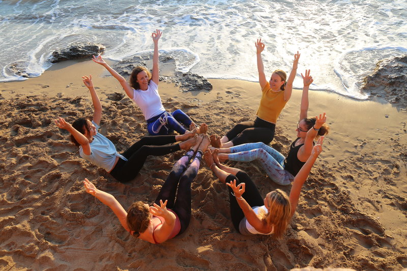 Graduates of 200 Hour Yoga Teacher Training Program Pose on the Beach in Greece