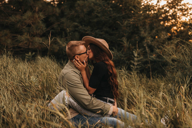 Kissing in the grass engagement
