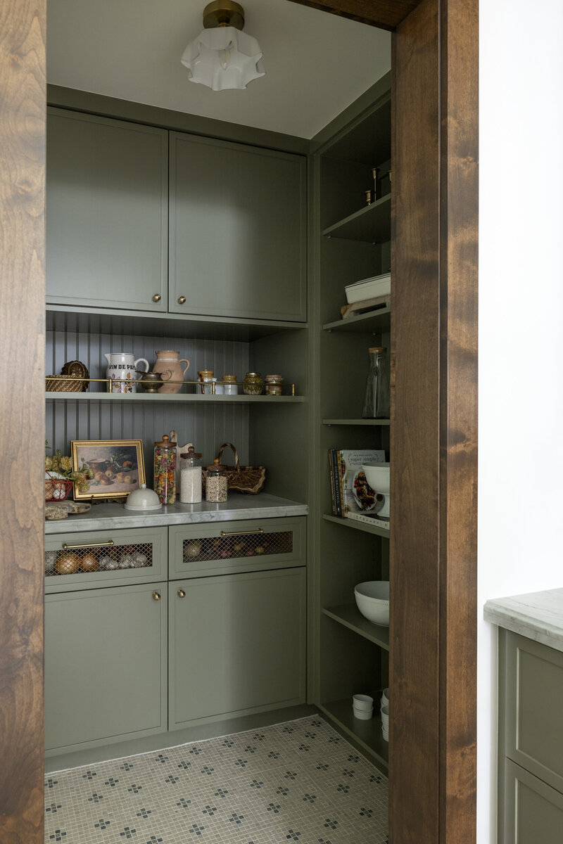 Orange county interior designer kitchen remodel. Painted cabinets with brass hardware, quartzite countertops, stained kitchen island with marble countertop and white oak wood floor.