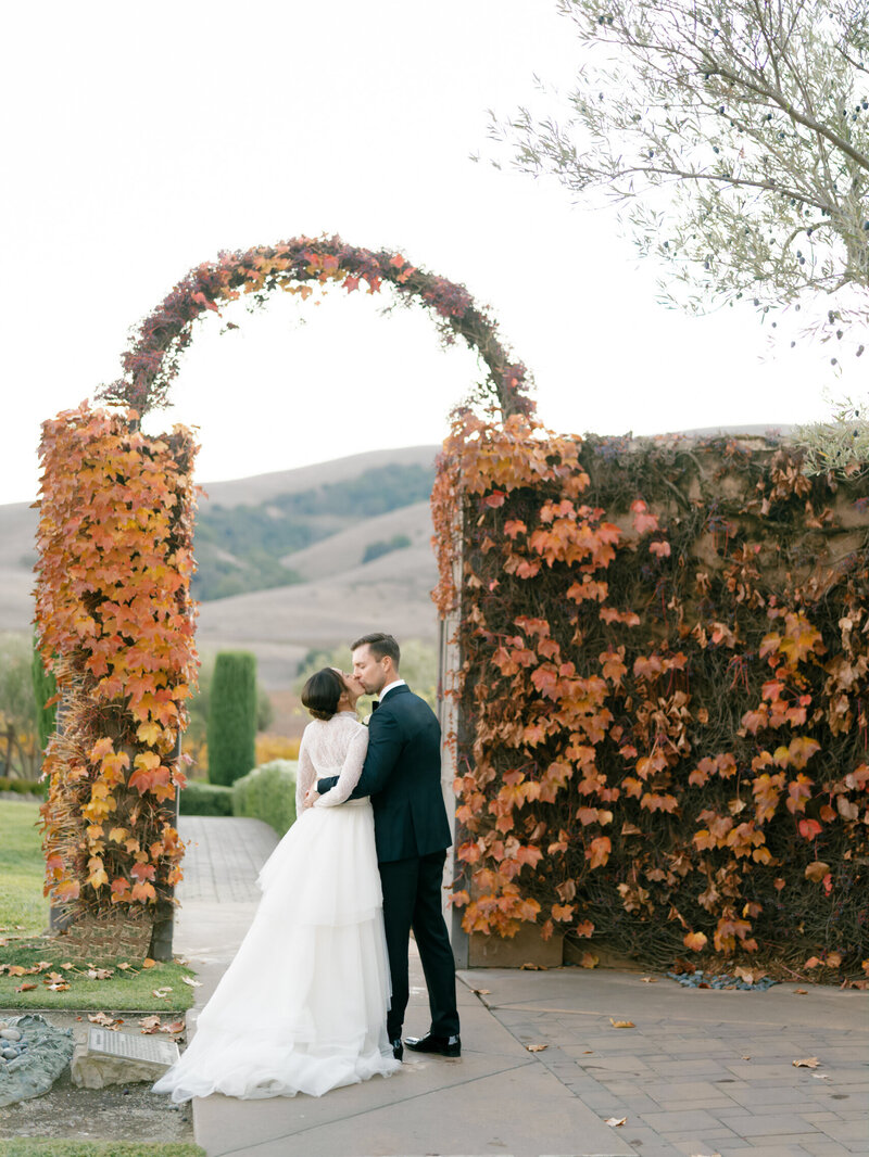 Bride and groom holding hands while walking down dirt path photographed by Chicago and destination editorial wedding photographer Arielle Peters