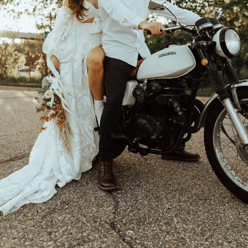 Bride and groom posing on motorcycle
