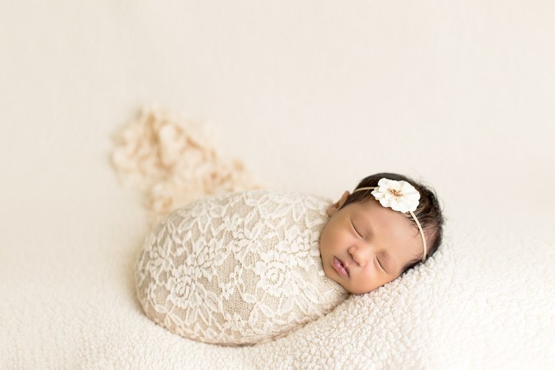 newborn with lace wrap