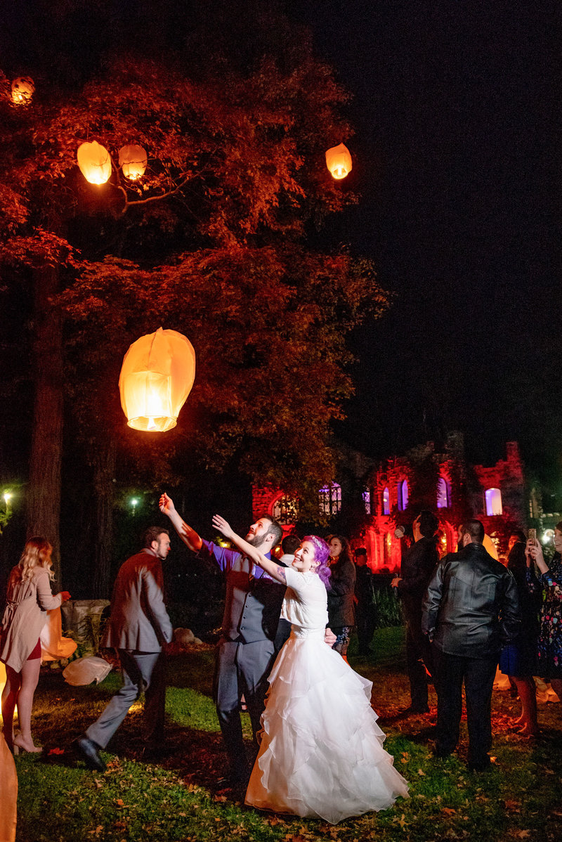 Bride and groom and guests release Chinese lanterns