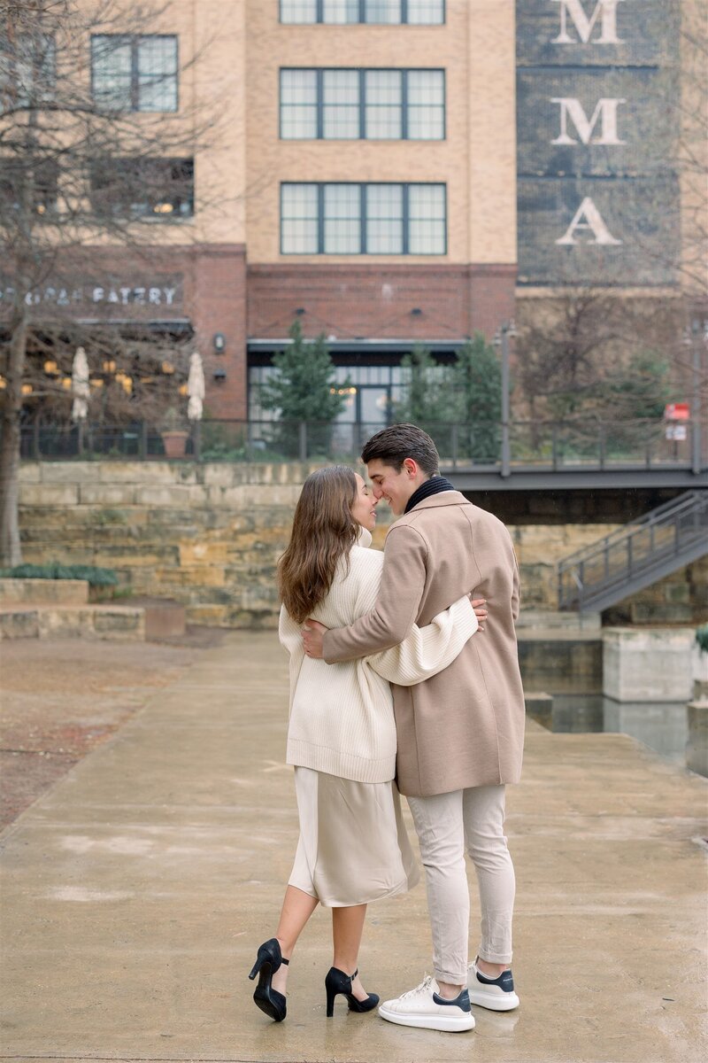 Engaged couple lovingly embracing each other neutral color palette Austin Engagement photographer
