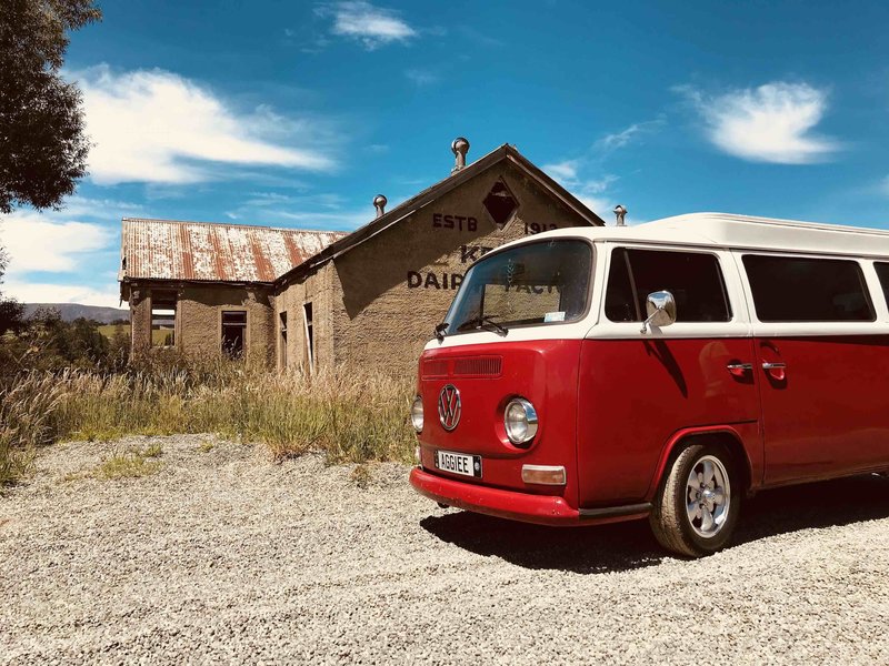 Aggiee, red kombi pictured outside the old Kelso Dairy Factory in South Otago, New Zealand