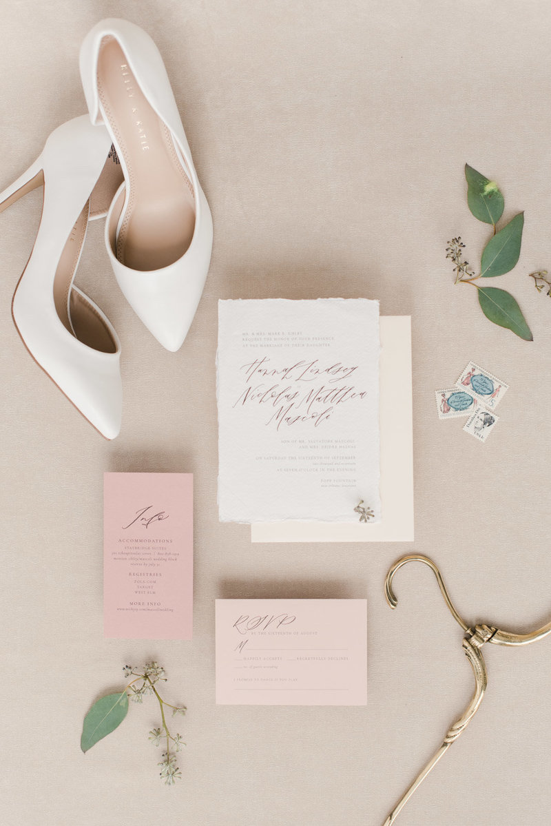 Flat lay with wedding shoes and wedding invitation