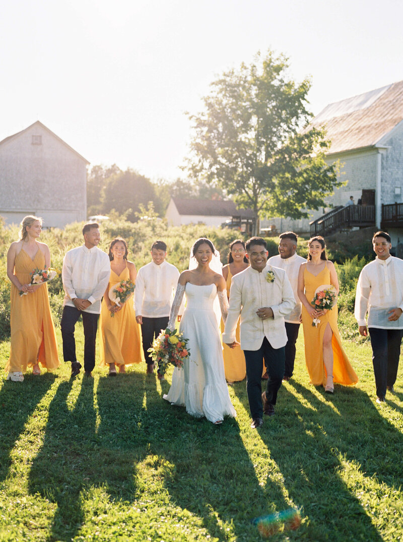 Bride and groom with bridal party in yellow and white