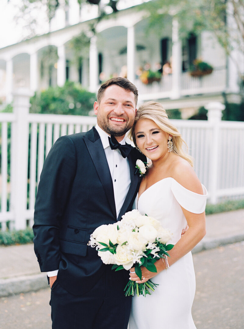 Film photographer in Charleston. Bride and groom standing in front of Thomas Bennett House during fall wedding in Charleston. Destination wedding photographer