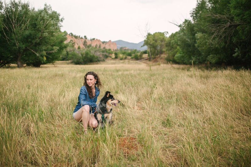 Wedding photographer with dog in a field in Colorado Springs