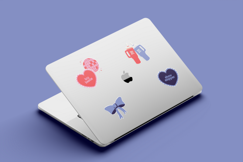 Macbook pro laptop with pink and purple on-brand stickers on a purple backdrop at Knoxville branding agency Liberty Type