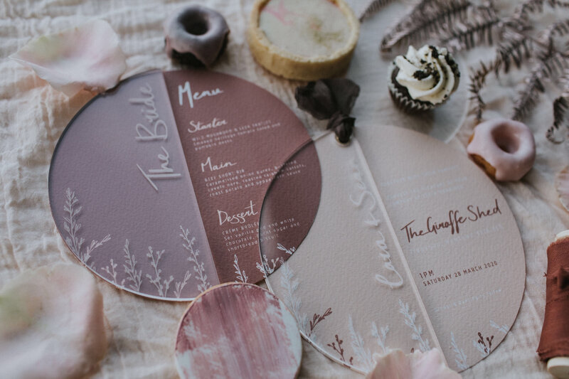 Circular acrylic place names and menus on a wedding table