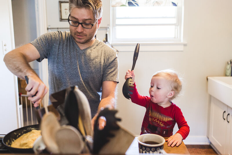 Father and son cooking together during documentary family photography session in Denver, Colorado