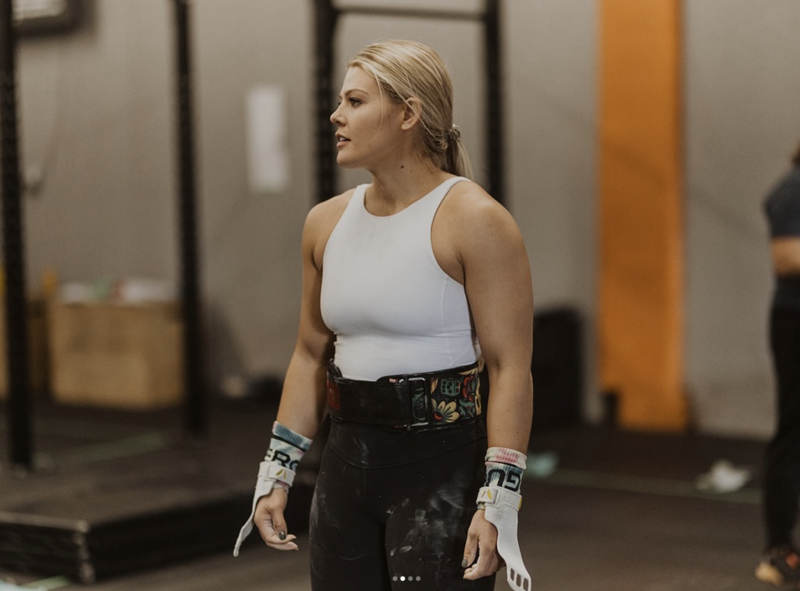 Personal Trainer hanging on fence