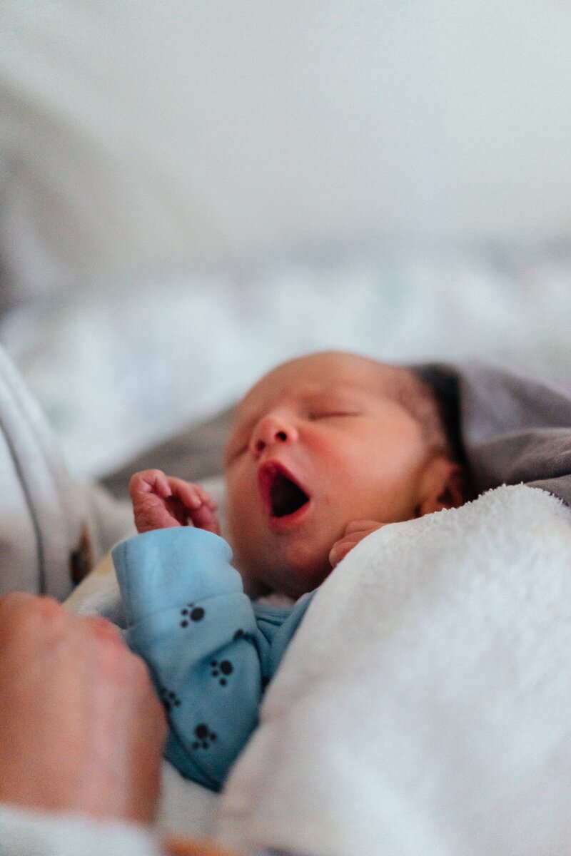 Tiny newborn baby yawning