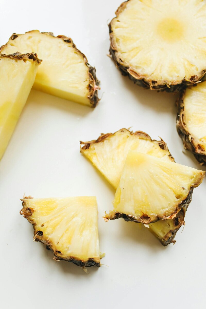 Flatlay image of pineapple slices on a white table