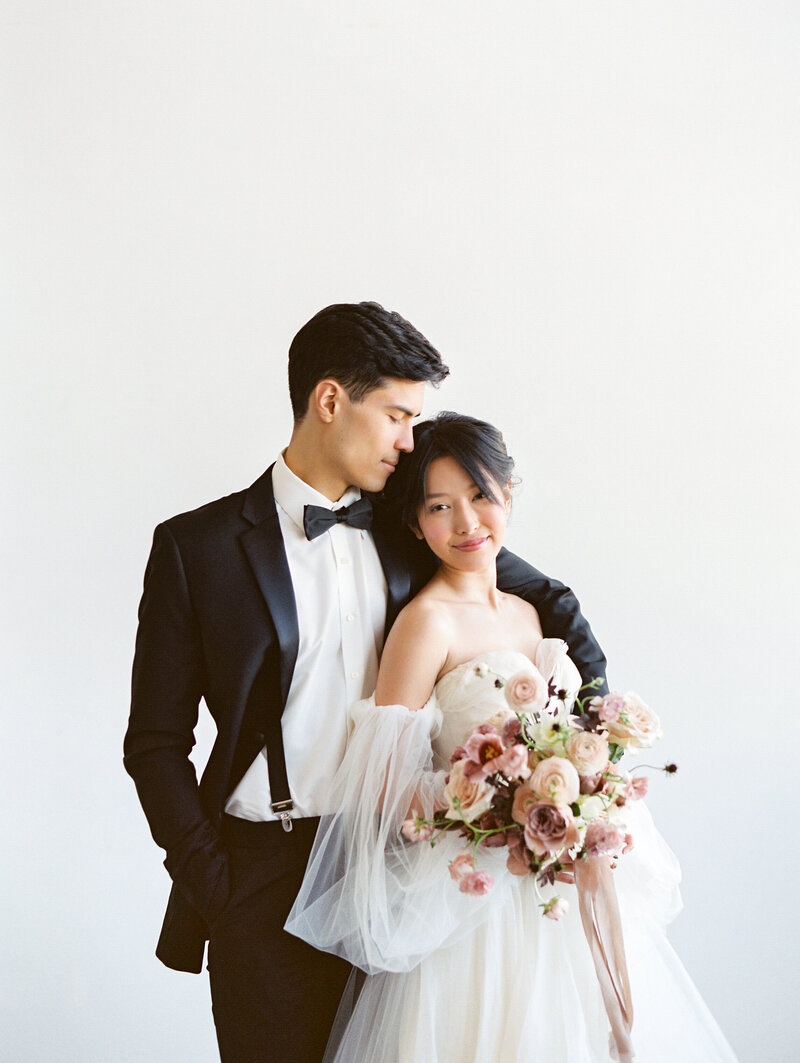 Asian bride and groom with pink florals