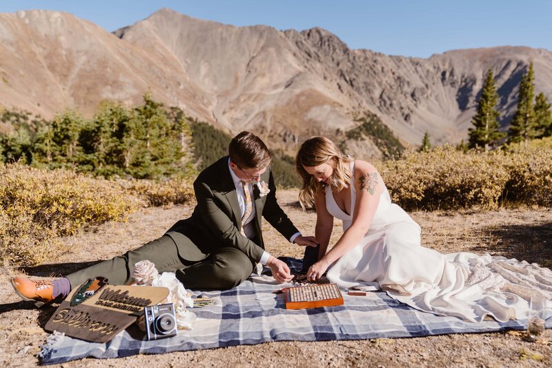 Couple plays chess during their elopement in Breckenridge, Colorado