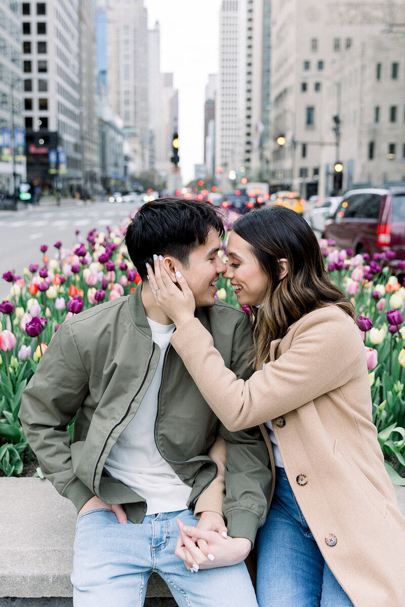 couple cuddling near tulips in chicago
