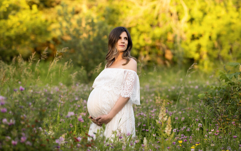 Pregnant woman in a white dress in a field in Richmond