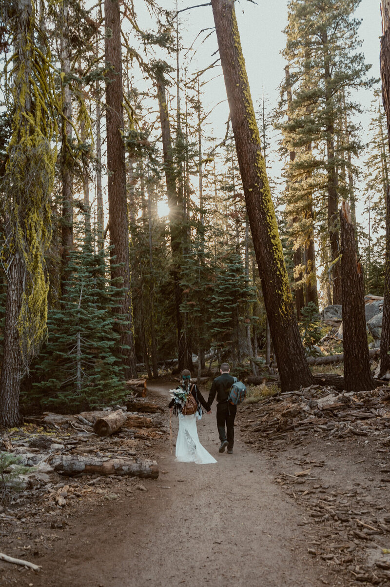bride and groom hiking to taft point